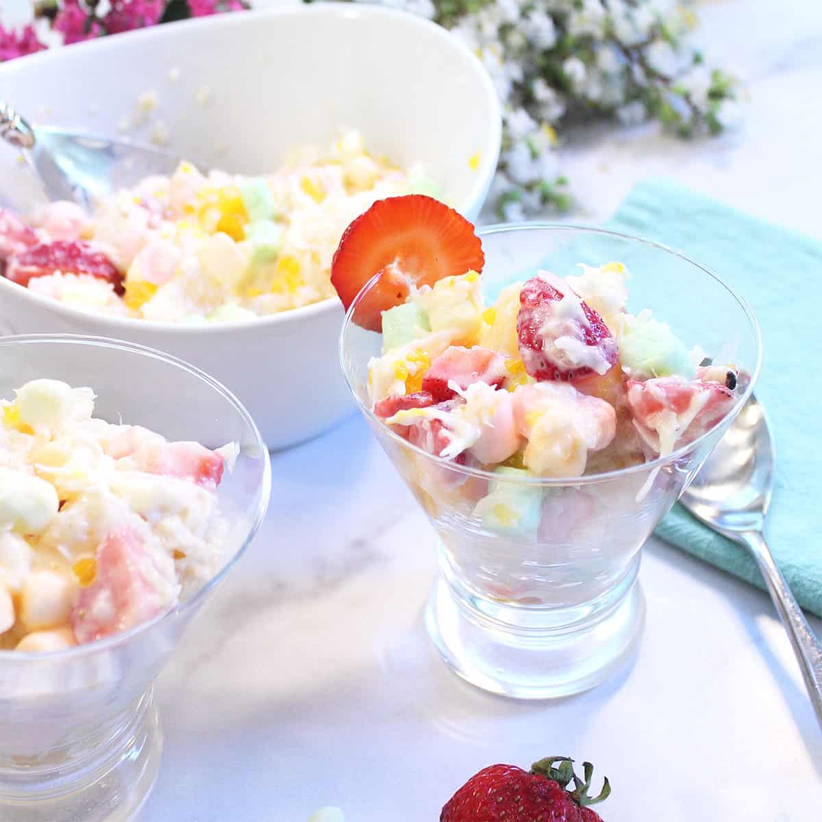 2 servings in front of serving bowl and flowers.