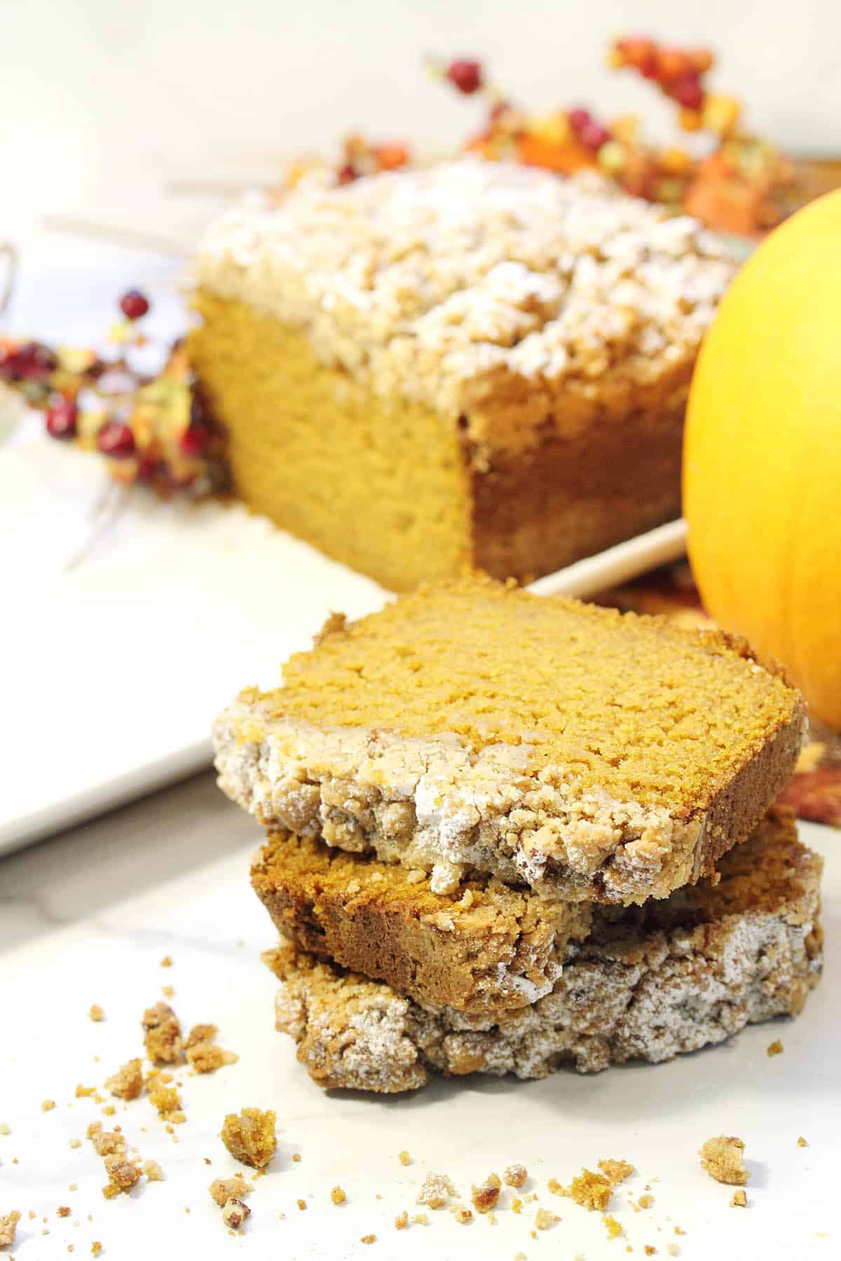 Closeup of stacked slices with crumbs on table.