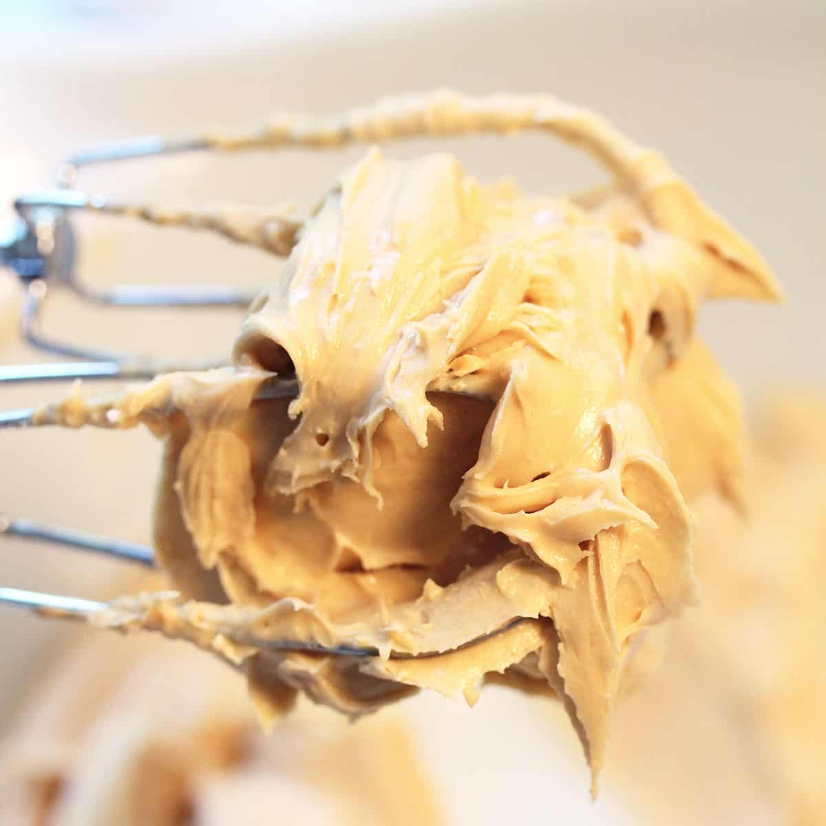 Closeup of frosting on beaters.