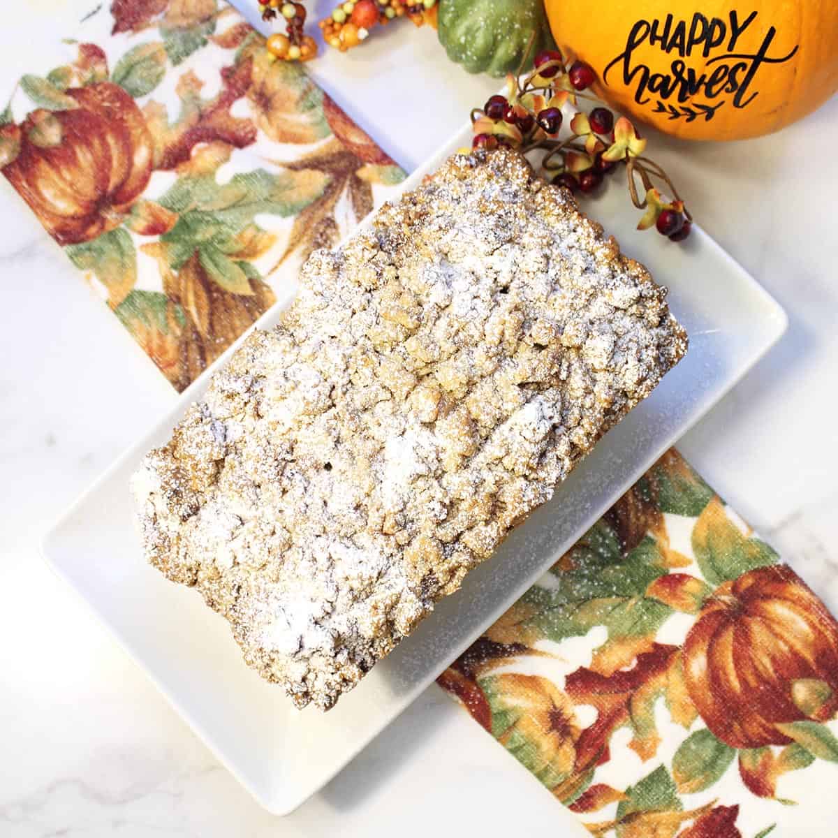 Overhead of baked bread showing powdered sugar crumbs.