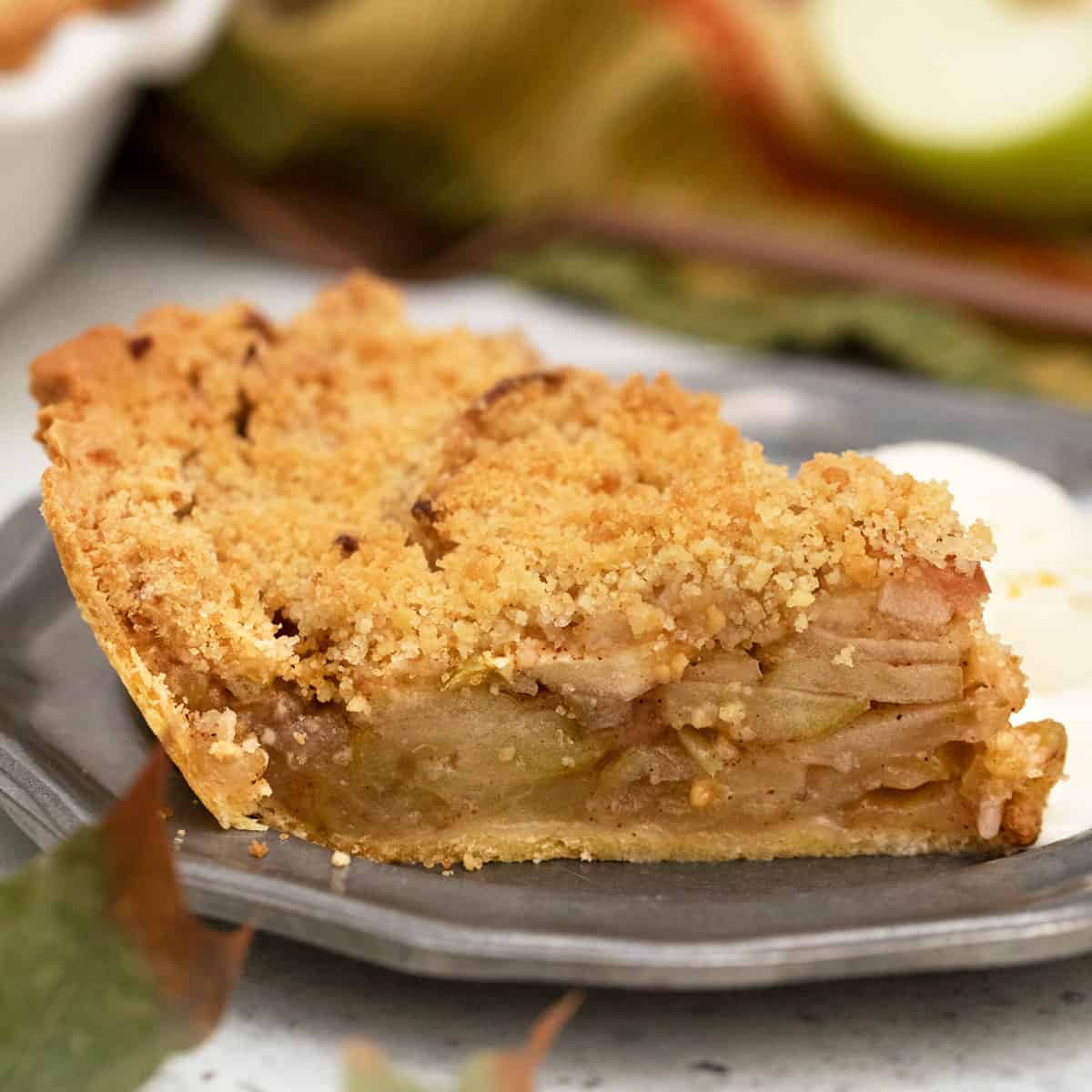 Side view of slice of apple pie showing layer of apples.
