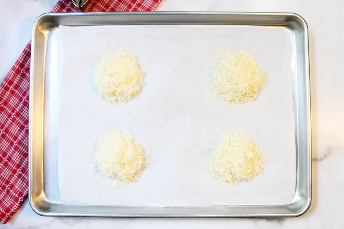 Piles of cheese on cookie sheet.
