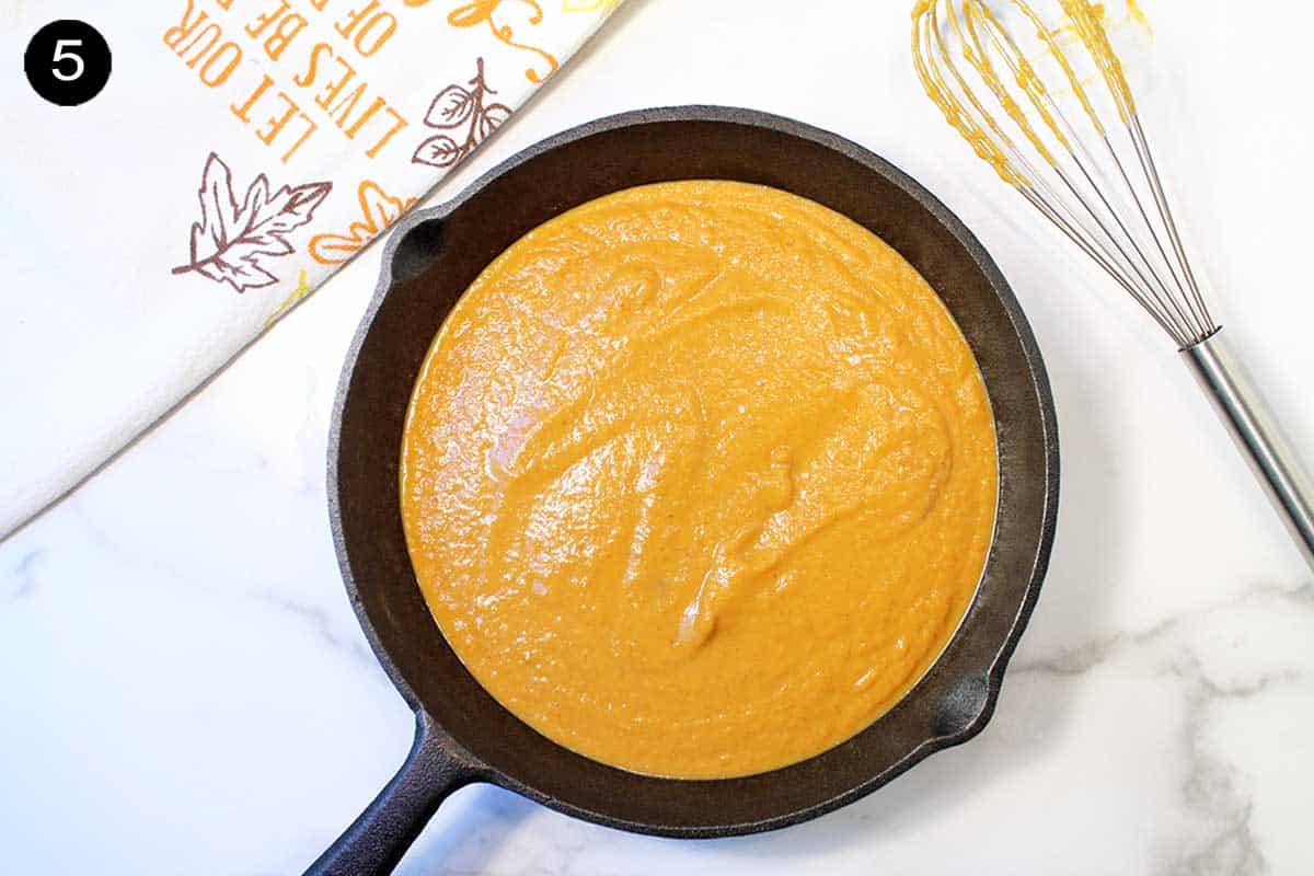 Pumpkin filling poured into skillet.