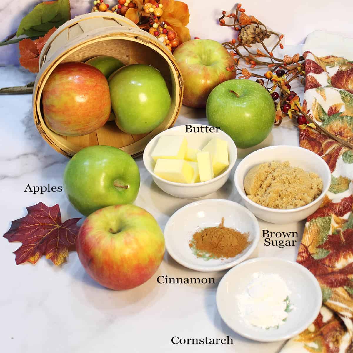 Sauteed cinnamon apples ingredients on white table, labeled.