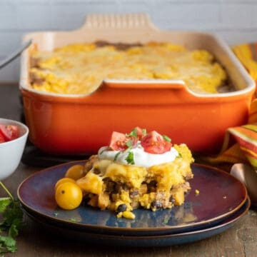 Serving of Black Bean Pumpkin Tamale Pie with casserole in back.