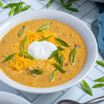 Crockpot Pumpkin Chili in bowl with sour cream garnish.