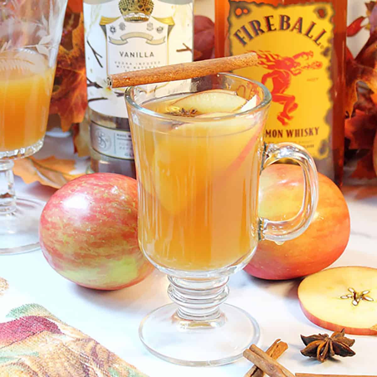 Mug of Fireball Apple Cider with cinnamon stick garnish.