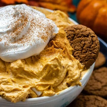 Pumpkin Fluff in bowl with garnish of whipped cream.