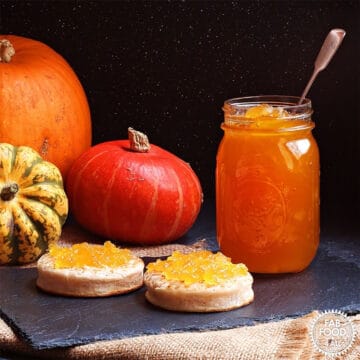 Pumpkin & Ginger Jam in jar and spread on two muffins.