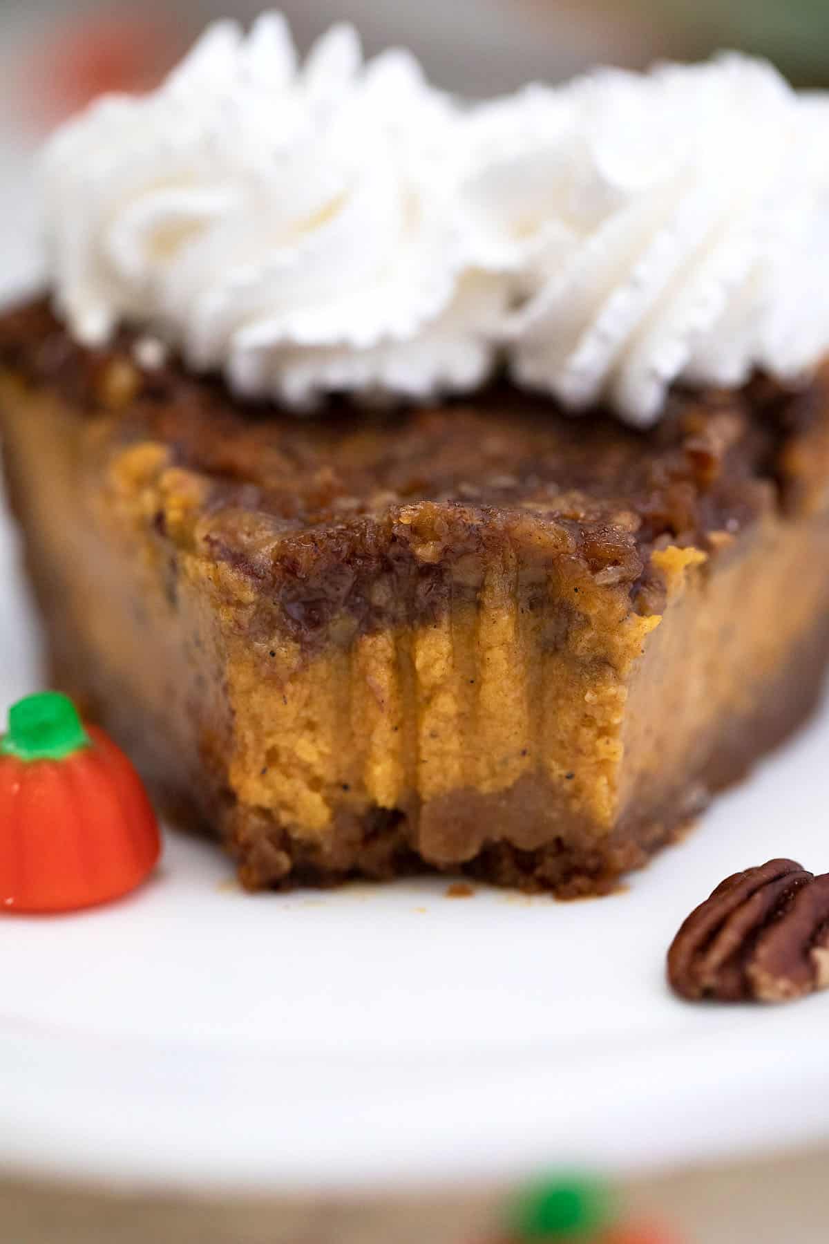 Closeup of slice of pie on white plate with bite taken out.