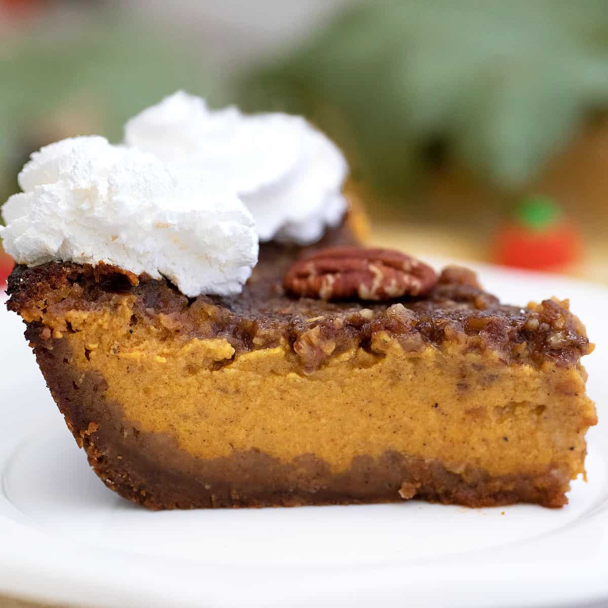 Sideview of slice of pumpkin pecan pie showing layers.