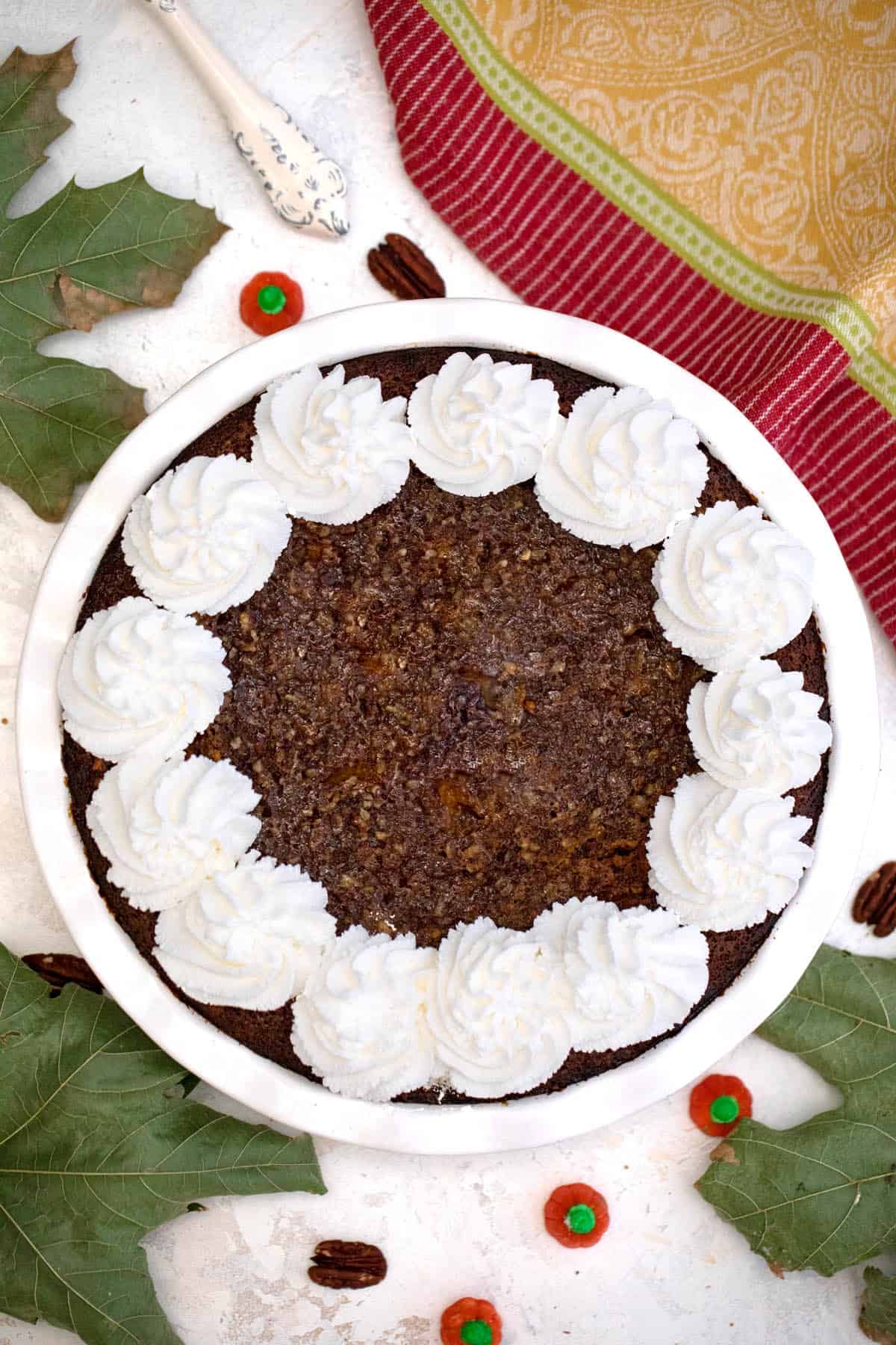 Overhead of baked pie with whipped cream dollops around edges.