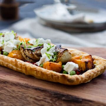 Pumpkin and Fennel Vegetable Tart on wooden serving board.