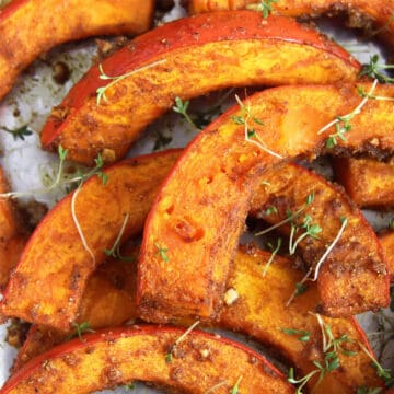 Close up of spicy pumpkin wedges on cookie sheet.