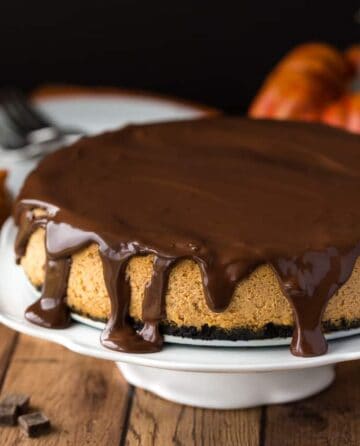 Chocolate Pumpkin Cheesecake on cake stand.
