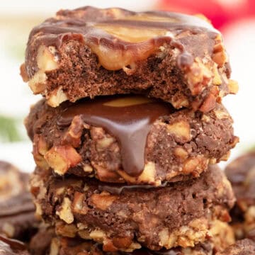 Stacked Turtle Thumbprint Cookies with bite taken out.