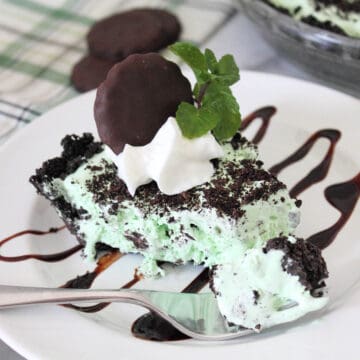 Slice of chocolate mint pie with bite on fork.