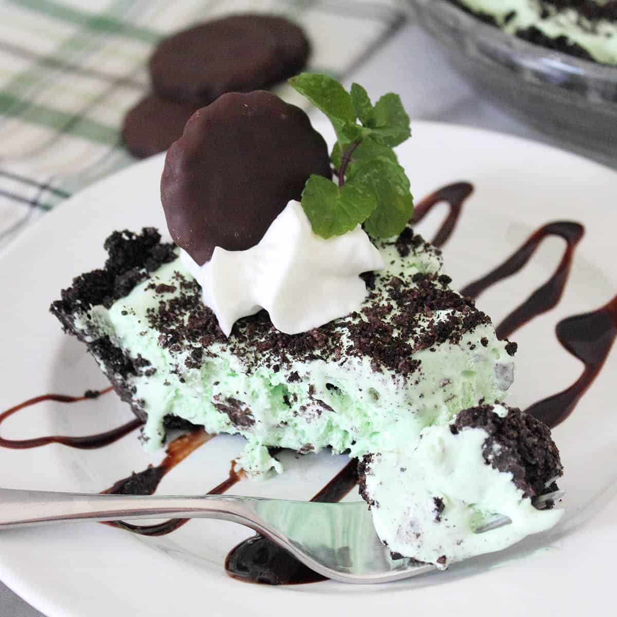 Slice of chocolate mint pie with bite on fork.