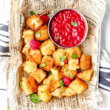 Fried Brie Bites in basket with dipping sauce.