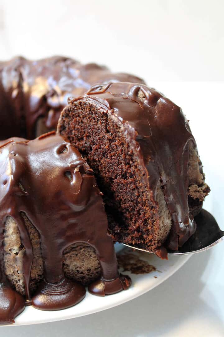 Lifting slice out of whole cake with cake server.