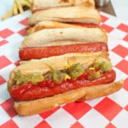 Air Fryer hot dogs lined up on red checkered paper.