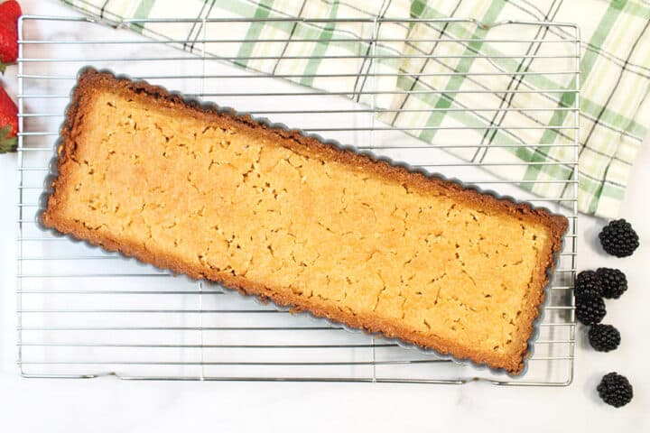Baked almond crust on wire rack.