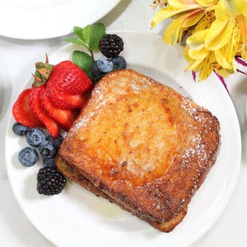 Air fryer French Toast plated with berries.
