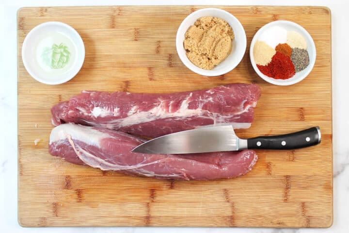 Tenderloin on cutting board with rub ingredients and showing how to remove silver skin.