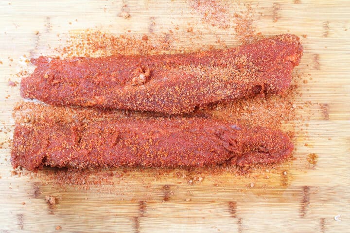 Cover the tenderloins with the rub and pat into meat.