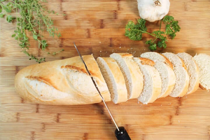 Slicing bread on cutting board.