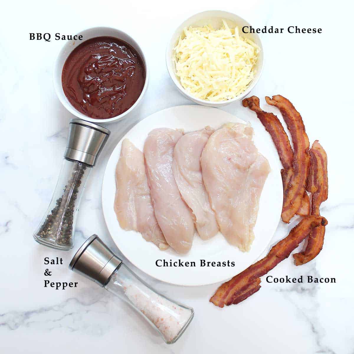 Oven baked BBQ Chicken ingredients on white table.