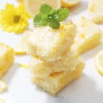 Stack of lemon brownies with mint leaf on top.