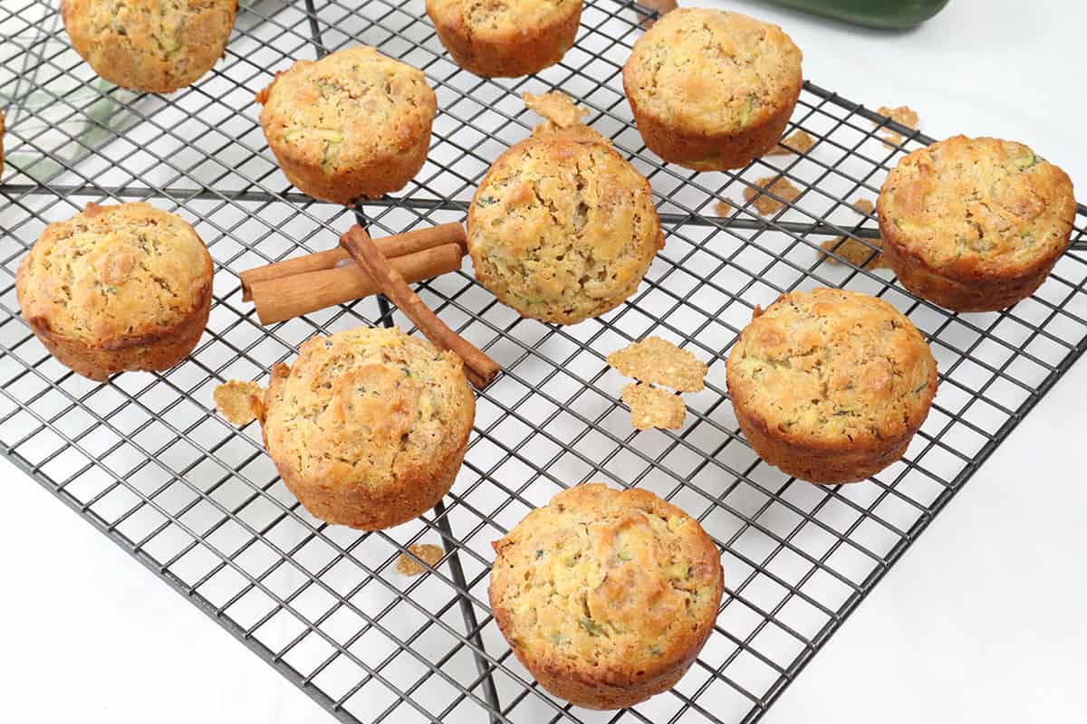 Bran muffins with zucchini cooling on wire rack.
