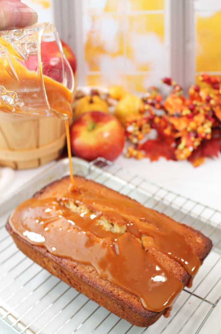Drizzling caramel glaze over donut cake.