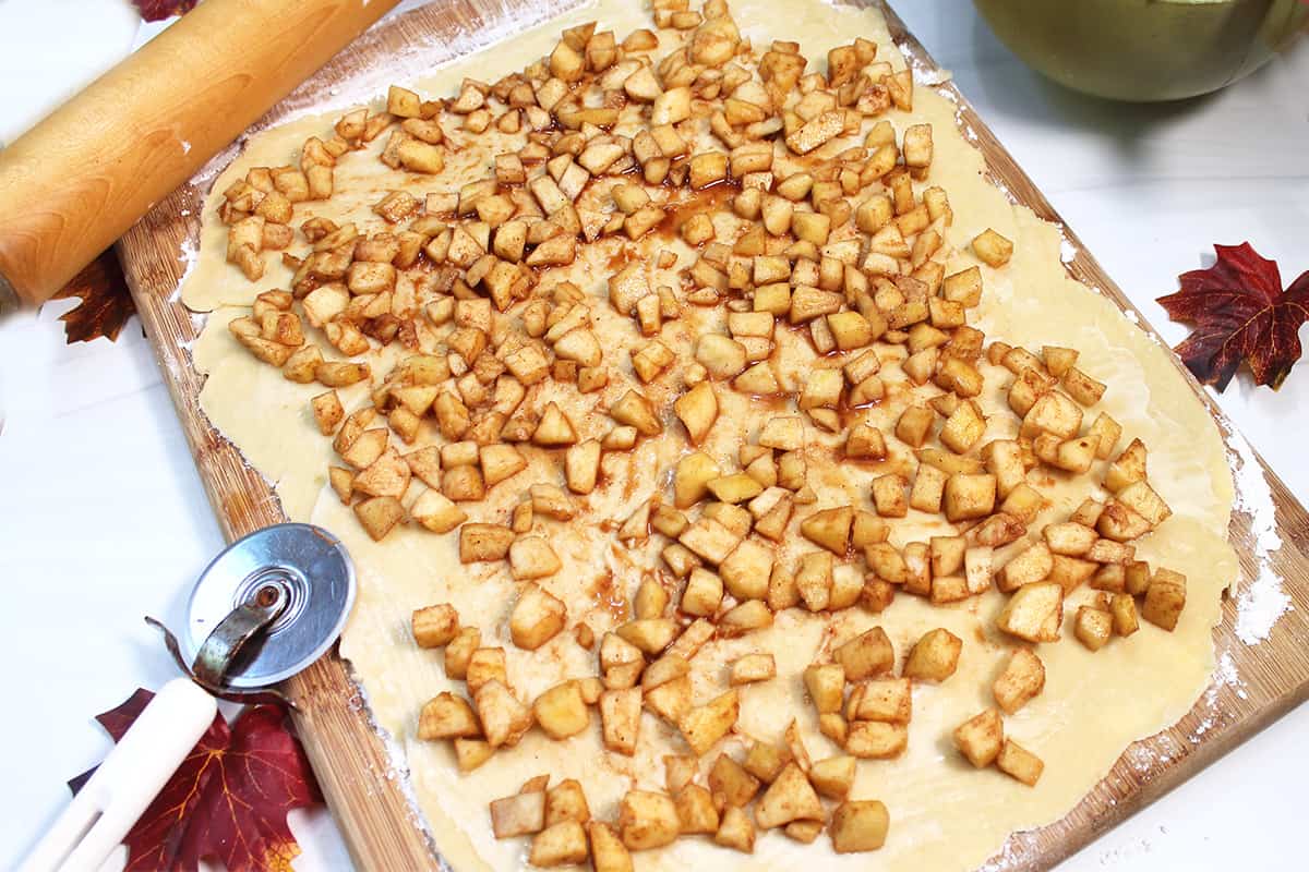 Spread cinnamon apple mixture onto rolled dough.