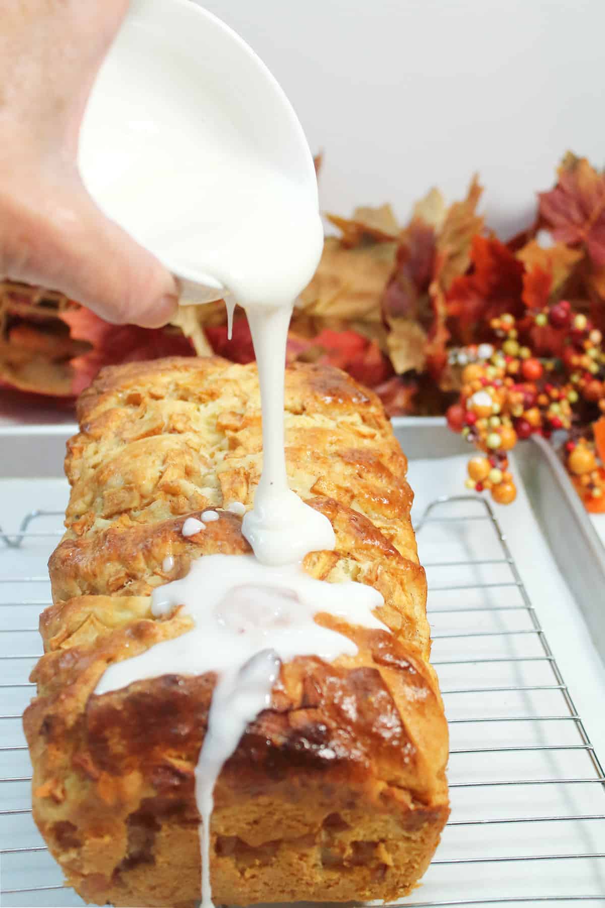 Pouring glaze over pull-apart bread.
