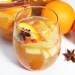 Closeup of glass of sangria with fruit and star anise in it.