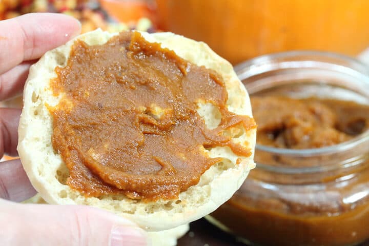 Closeup holding a muffin spread with pumpkin butter.