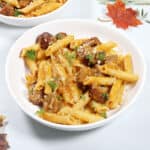 Bowlful of sausage and pasta with pumpkin sauce.