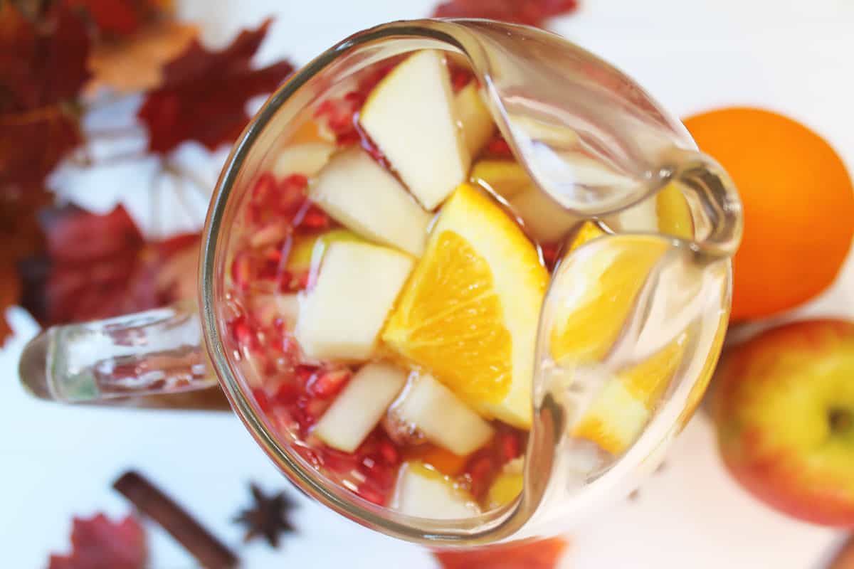 Overhead closeup of pitcher of sangria with fruit.