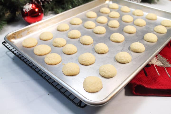 Baked shortbread cookies on baking sheet.