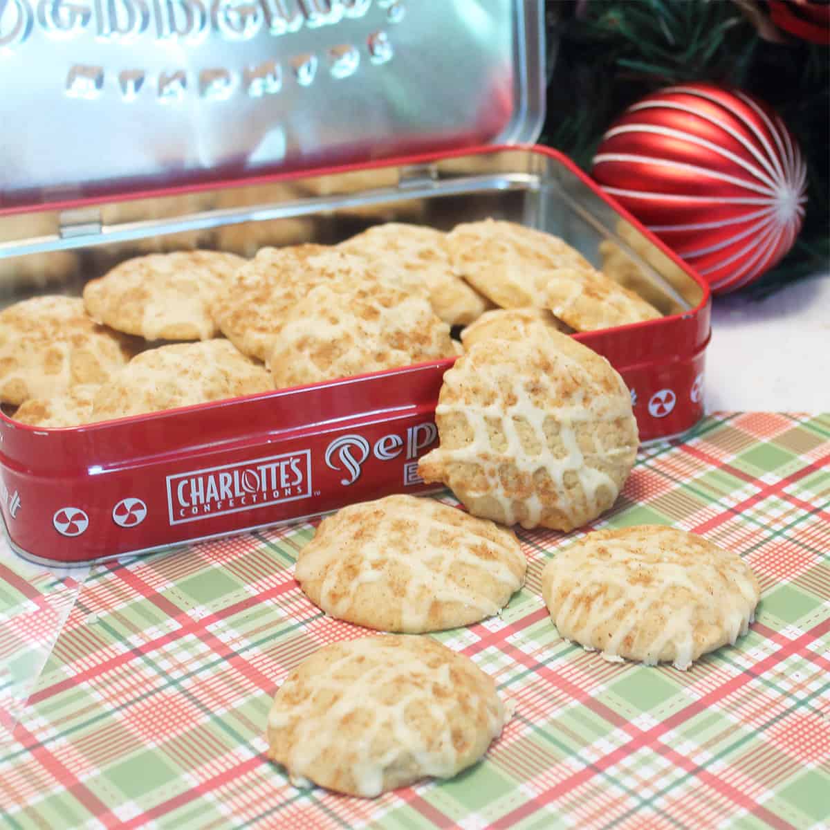 Frosted eggnog cookies in cookie tin.