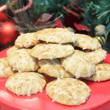 Eggnog cookies on red cake stand.