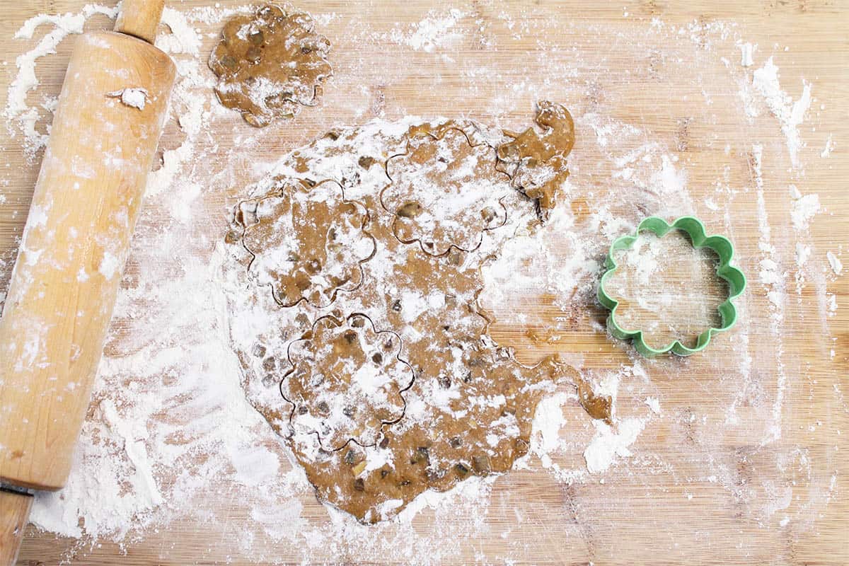 Cutting dough with cookie cutters.