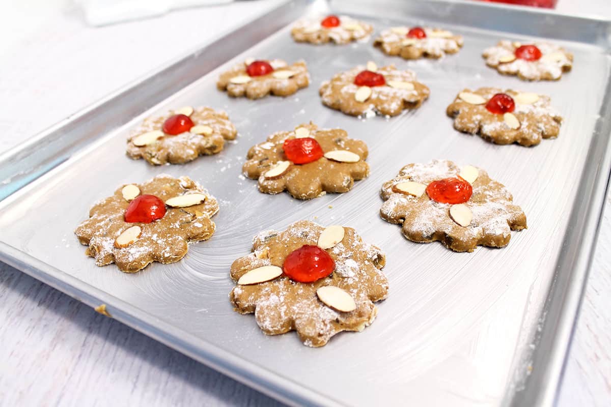 Ready to bake decorated cookies on cookie sheet.