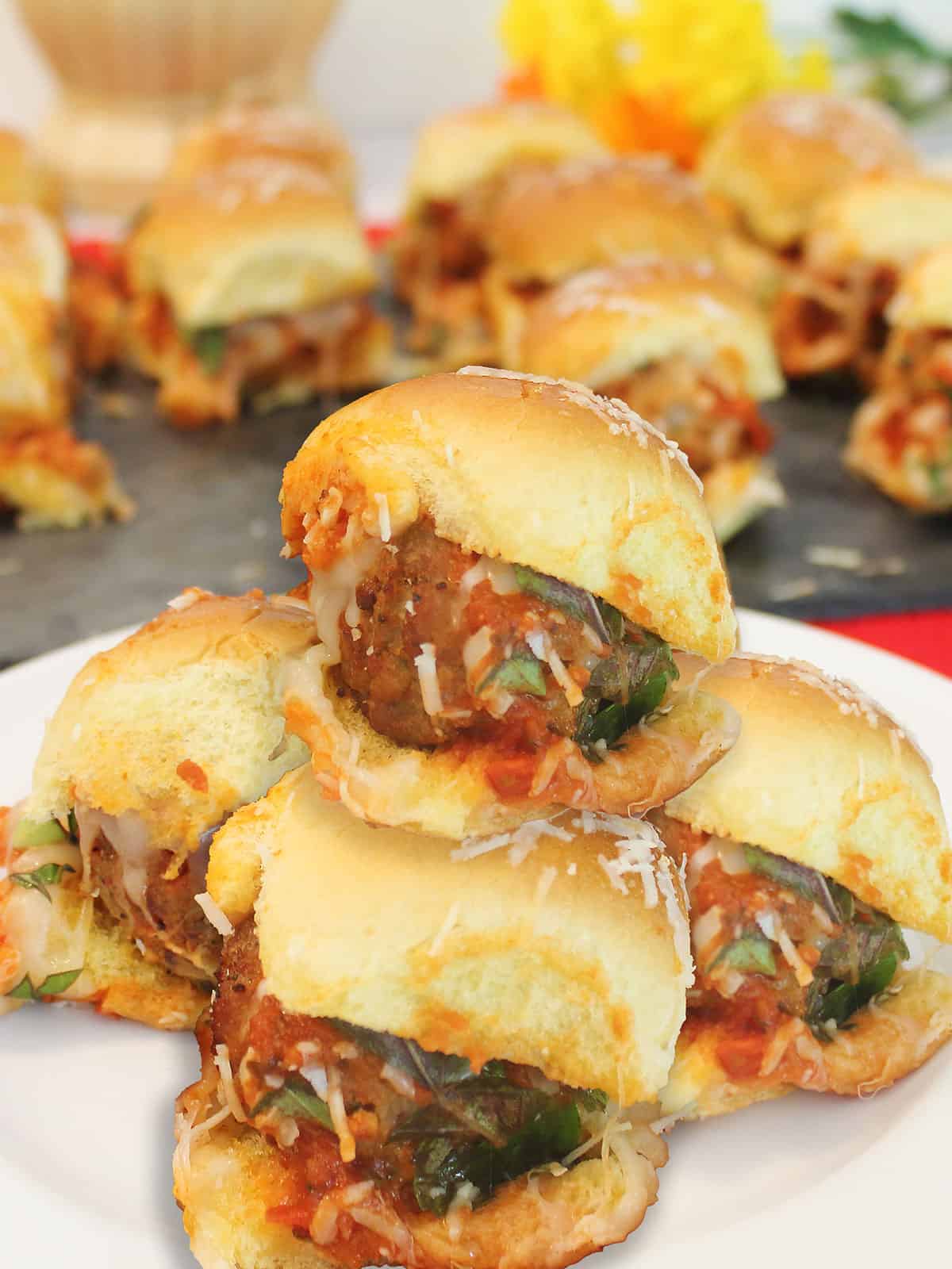 Sliders stacked on a plate.