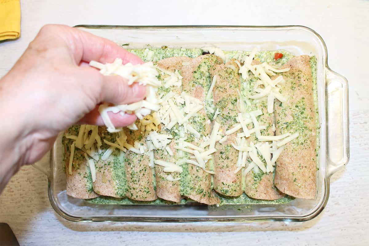 Sprinkling cheese over baked tortillas.