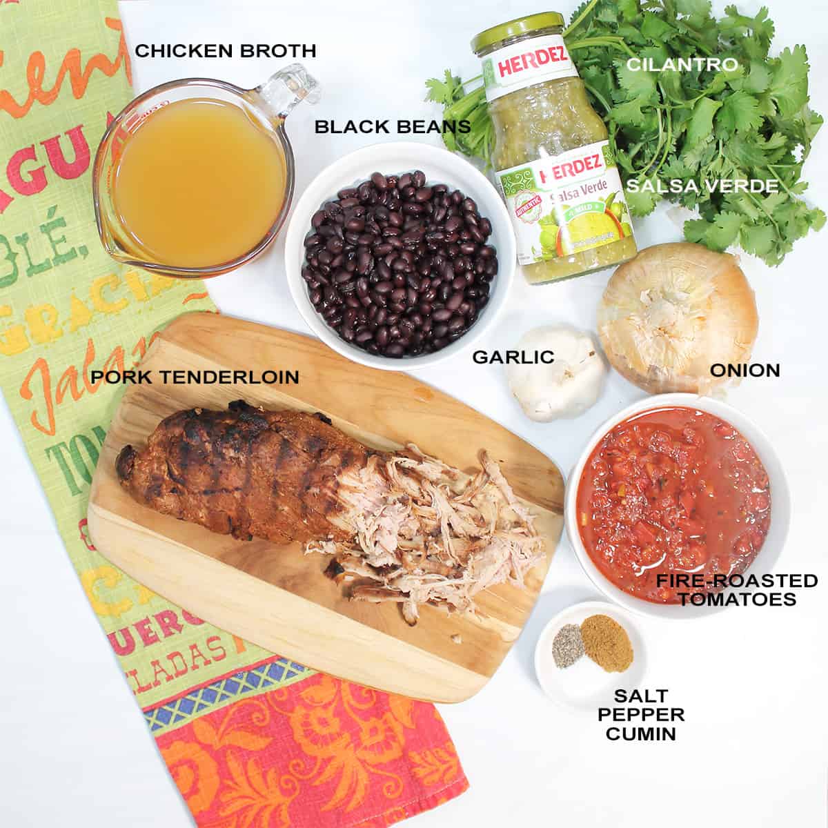 Ingredients for pork stew on white table.