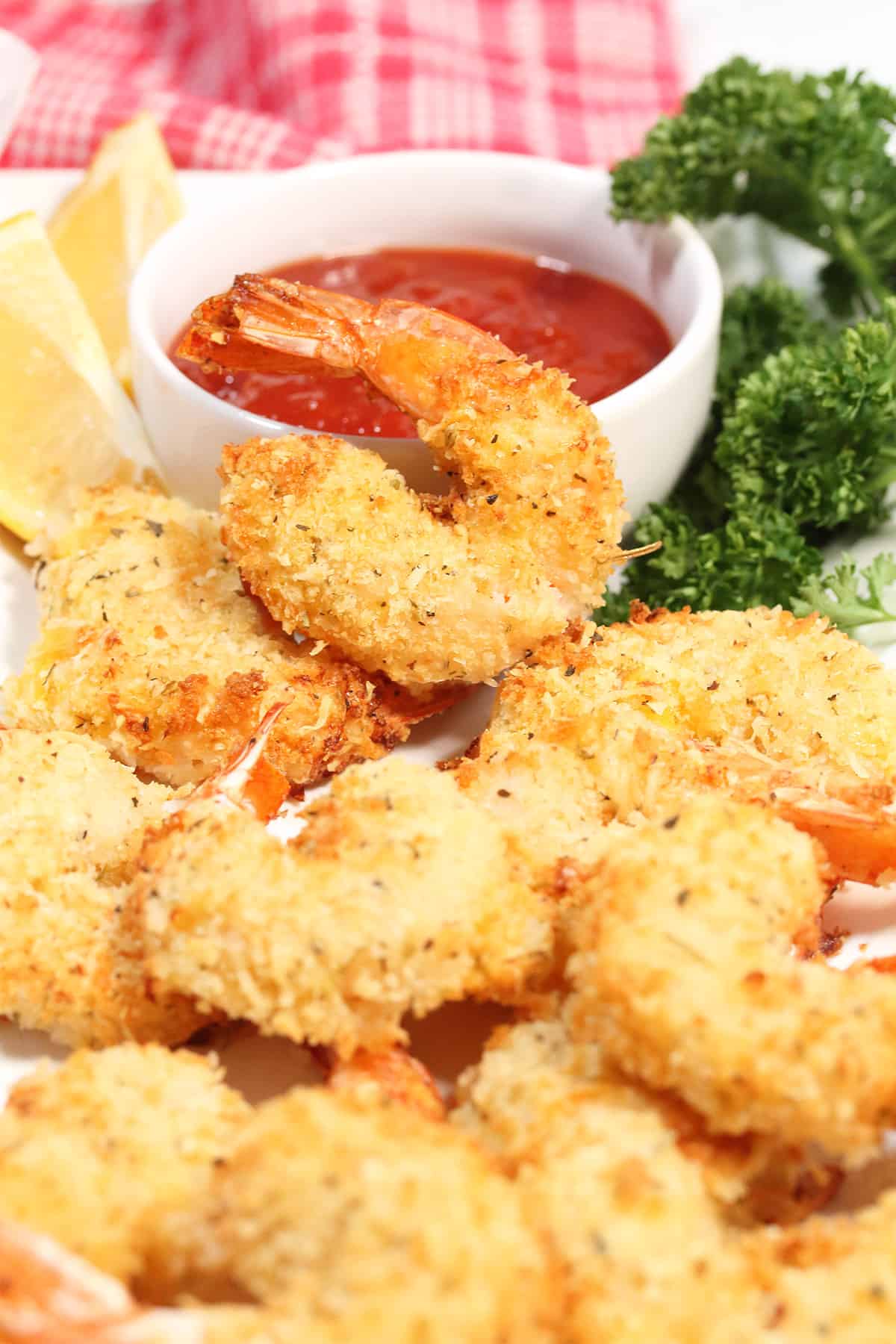 Platter of easy air fryer shrimp by cocktail sauce.