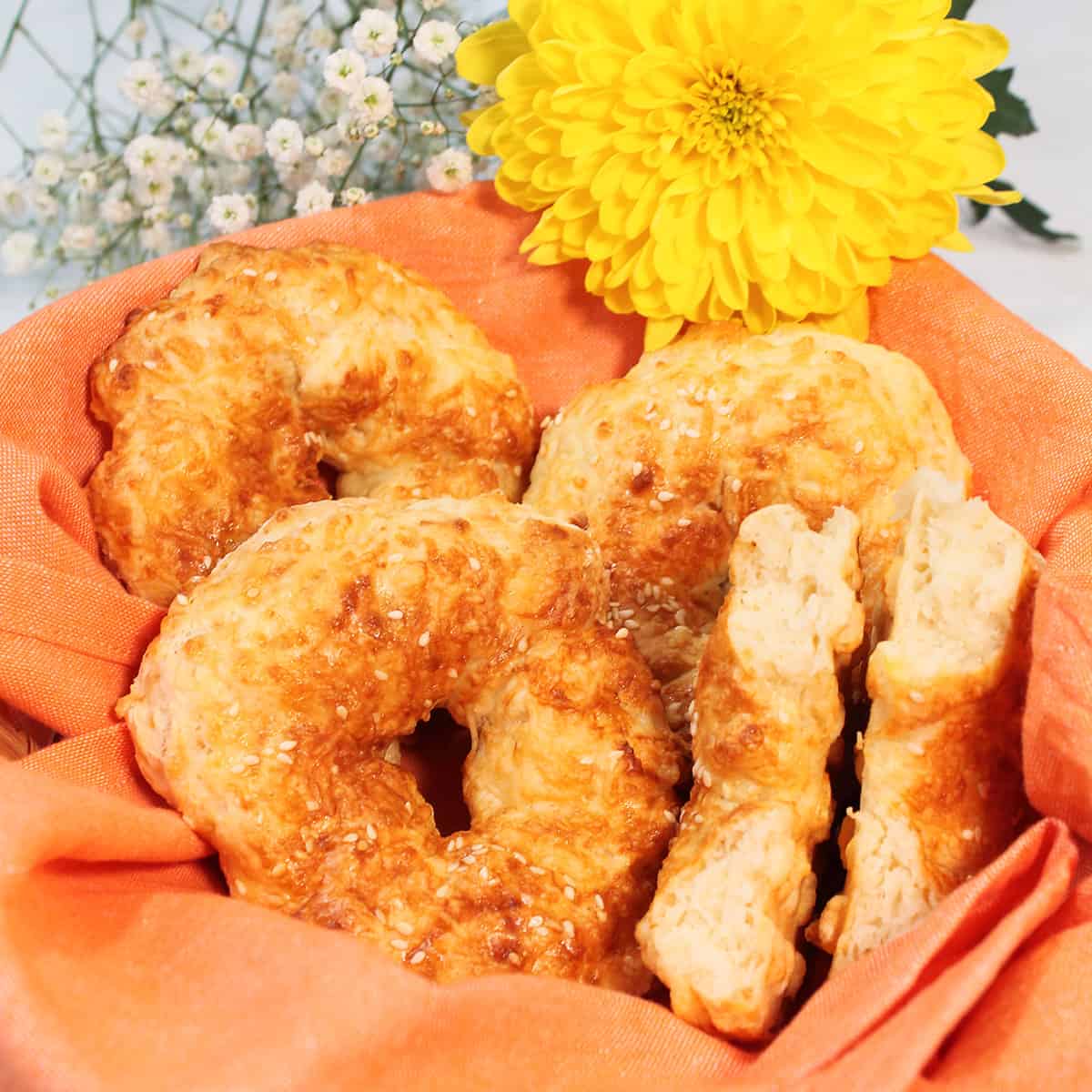 Basket of bagels with orange lining.